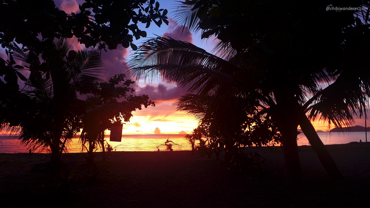 A boat in a beach over the sunset