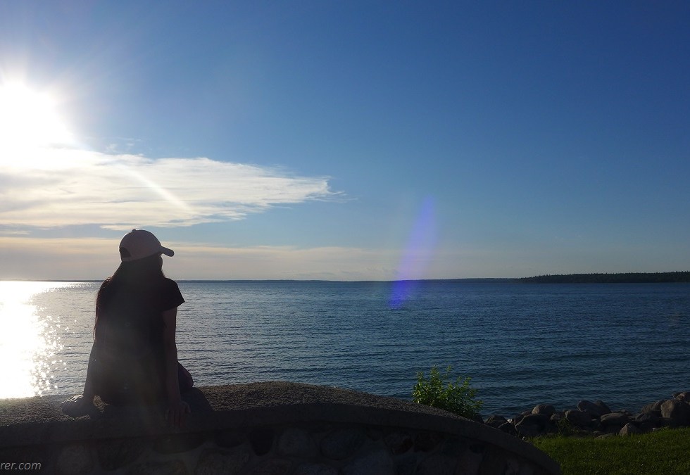 lady in a lake under the sunset